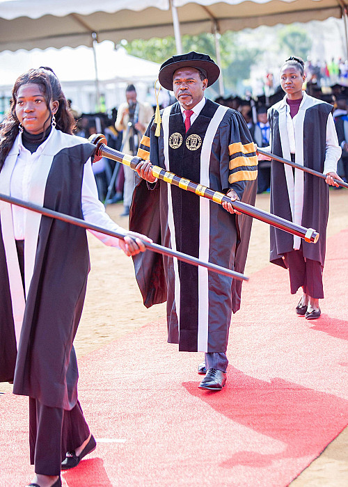 The DVC with escort matches forward bearing the university's Mace