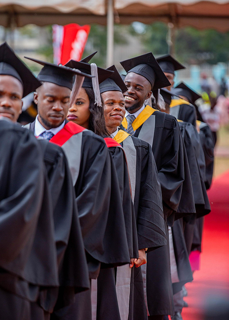 Excited graduates queue to receive their certificates