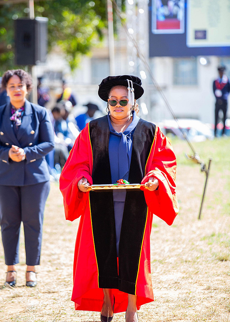 The Director of student affairs bringing the MUBAS Strategic Plan booklet