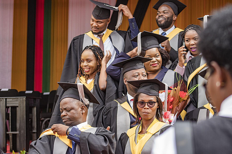 Joyful graduates pose after being awarded their certificates