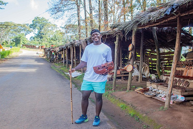Up the mountain a hiker admiring Sculptures made by locals